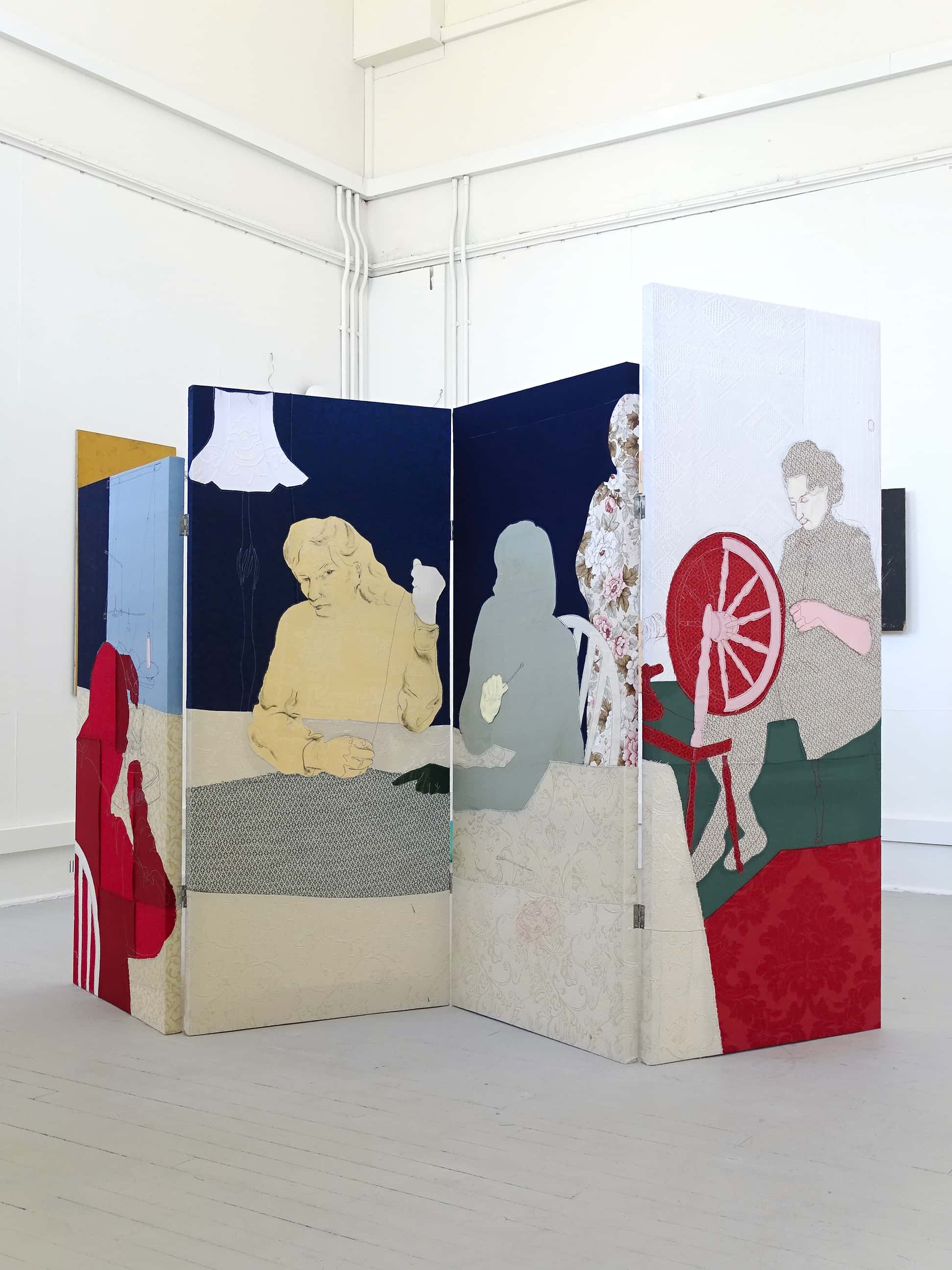 A draught screen composed of patterned fabric. Displays four Craftswomen Sewing, Crocheting and Spinning. 