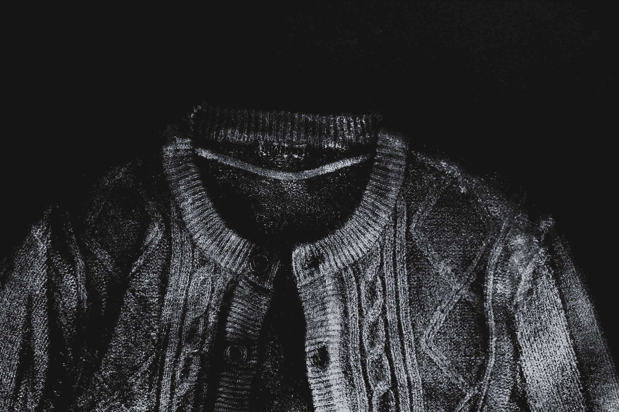 Close up of black and white print of knitted cardigan.