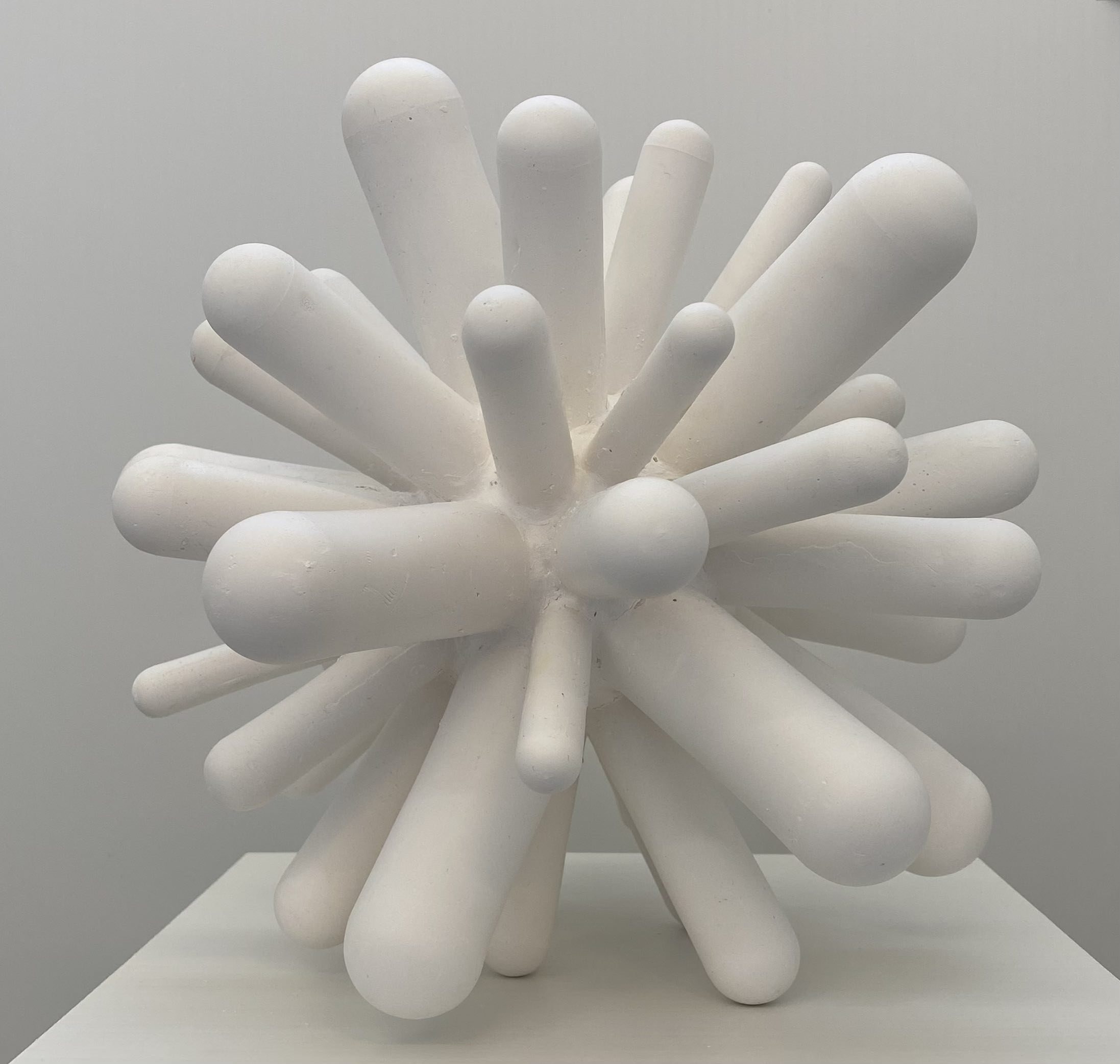 Photograph of an atomic-shaped plaster sculpture.