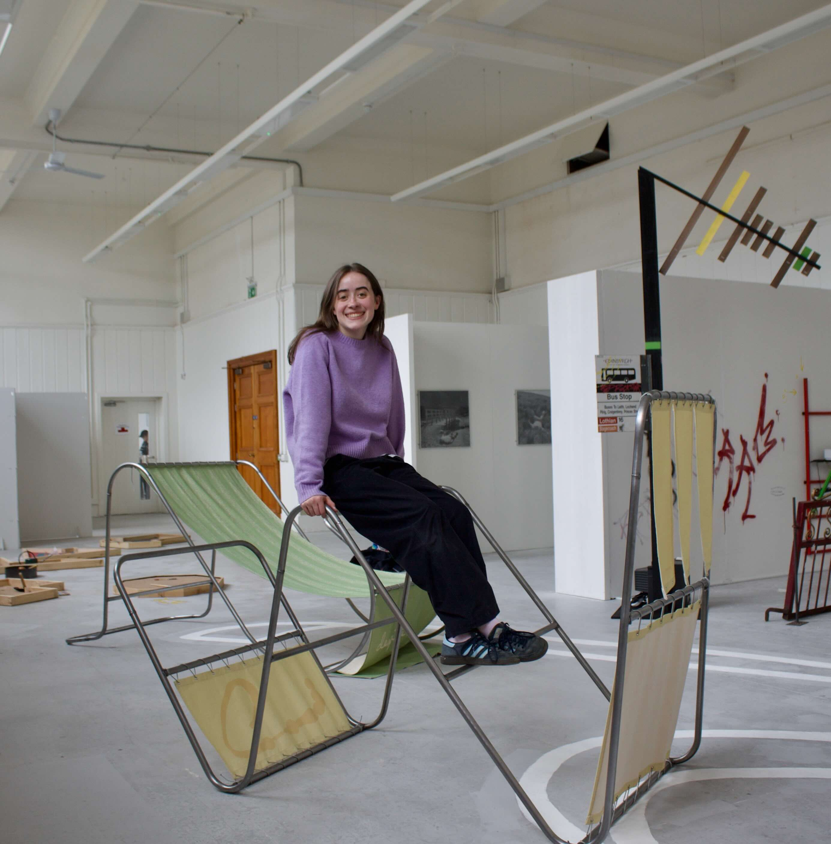 Picture of the artist (Ella Crawford) on the 'n frame', Installation view, Edinburgh College of Art Graduate Exhibition 2026