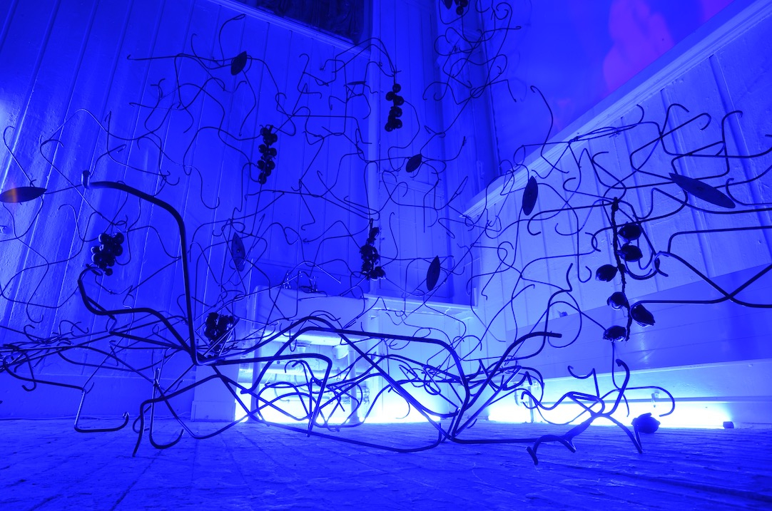 metal section of graduate show installation in blue light