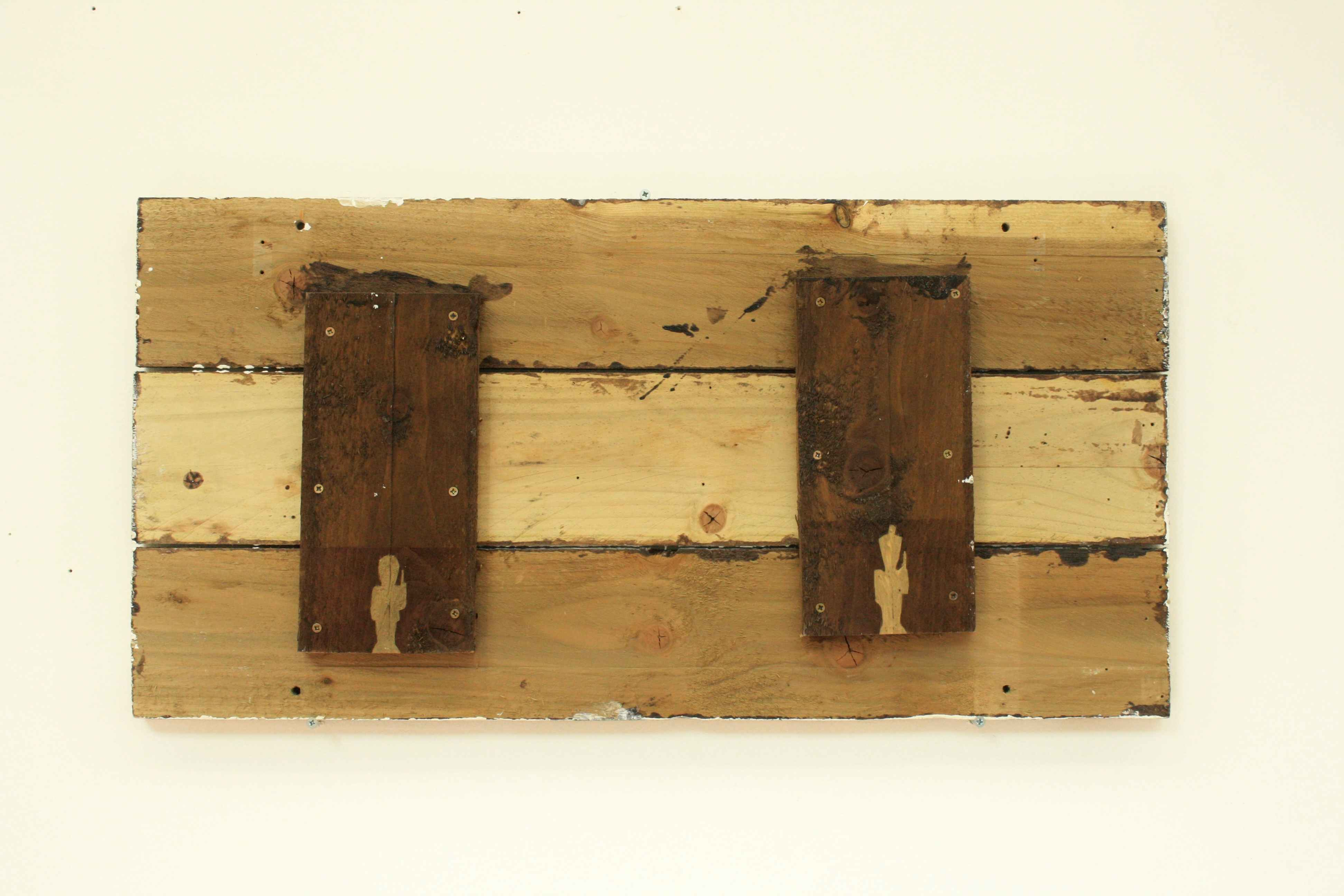 wooden panel on wall with soldiers carved into it 