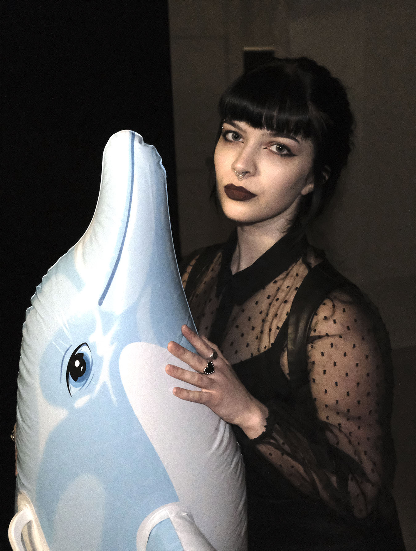 Person with an inflatable dolphin