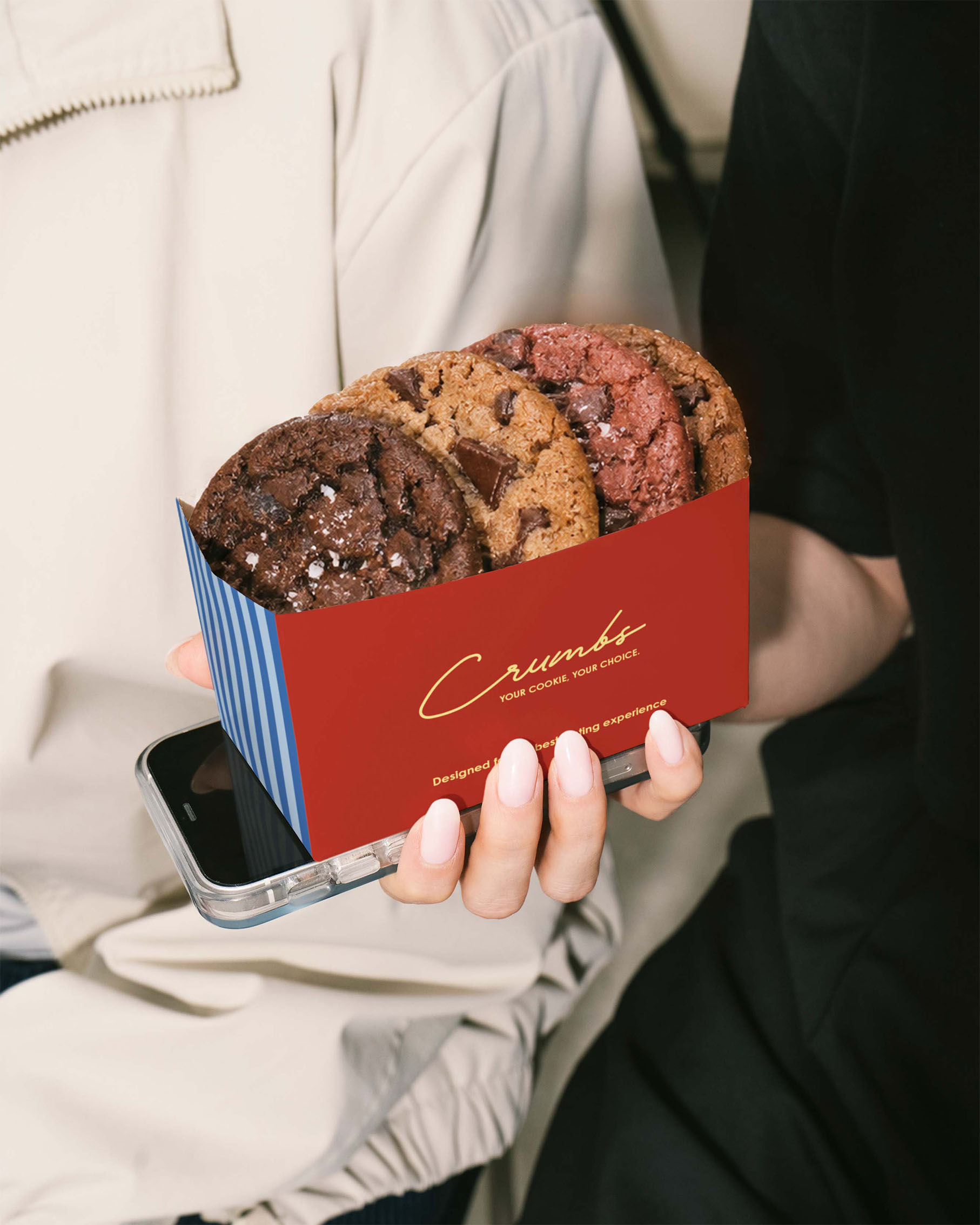 Holding a box of cookies in one hand