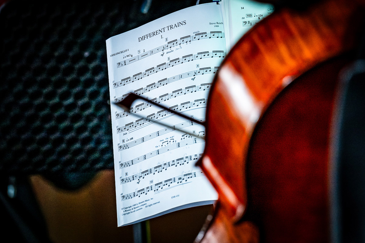 A close up of a sheet of music. It is partially obscured by the side of a violin.